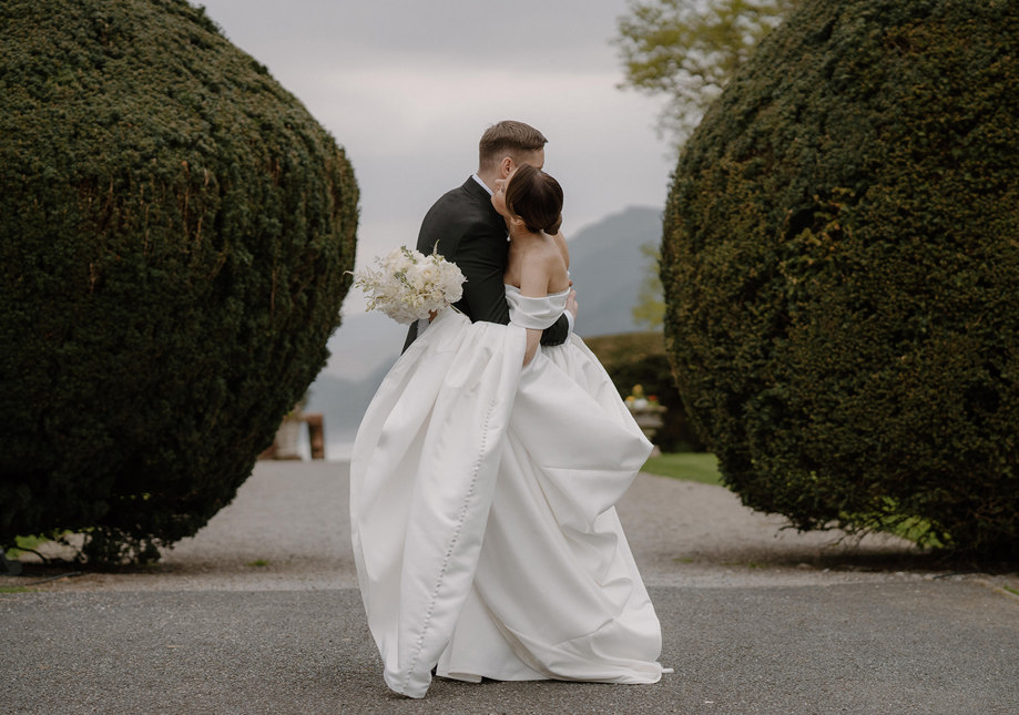 Groom kisses brides hand at top table