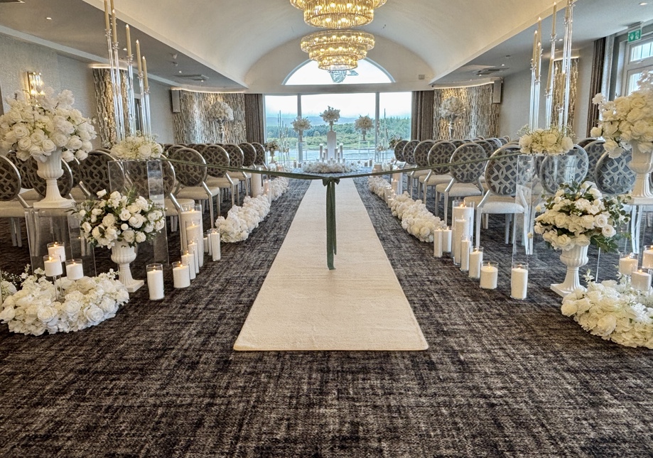 Lochside House Hotel Ceremony with white florals and wax sand candles