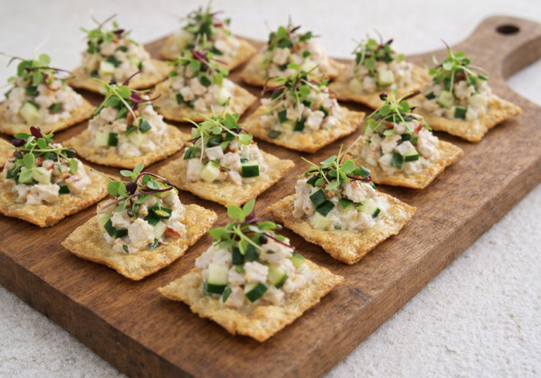 Seafood canapé bites on crisp crackers with cucumber and microgreens served at a Scottish wedding by The Tasty Hog Company