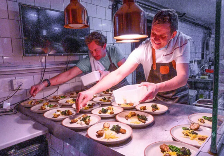 Wylie & Wood chefs plating fine dining dishes for a wedding celebration.