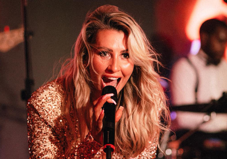 Laura Purdue Wedding Vocalist singing live during a high-energy wedding reception