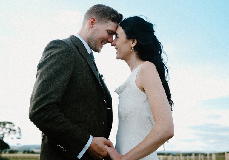 Scottish wedding couple holding hands during relaxed outdoor portraits by Kamila Pickles Photography