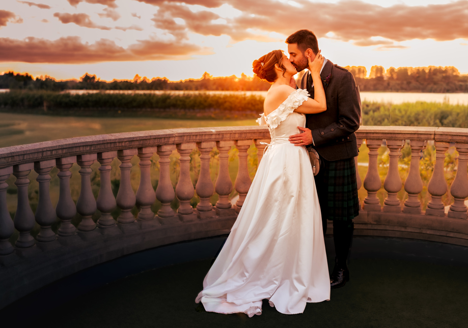 Bride and Groom embracing at Sunset on balcony at Gailes Ayrshire