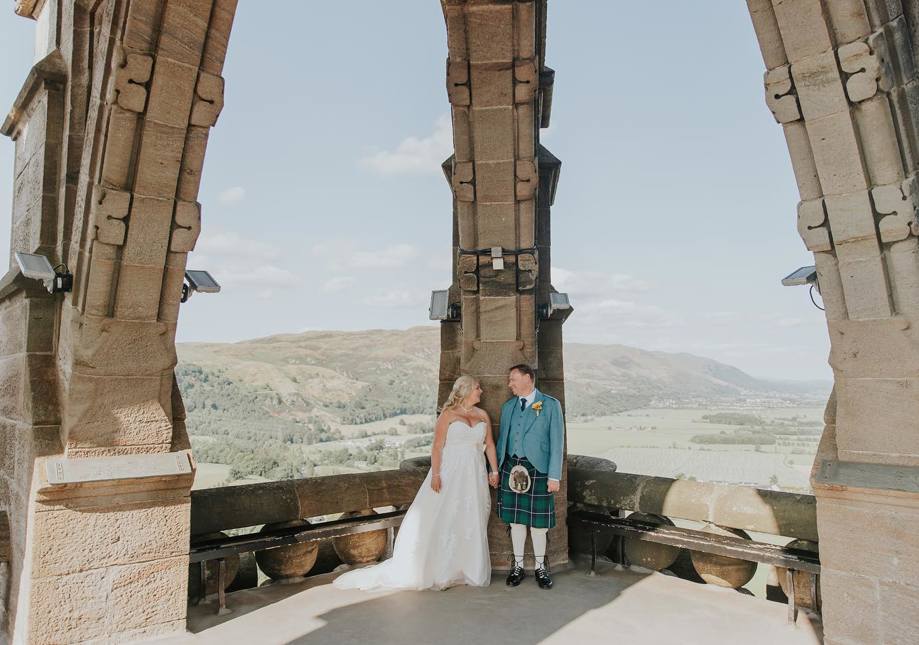 Bride and Groom standing at the top of The National Wallace Monument 