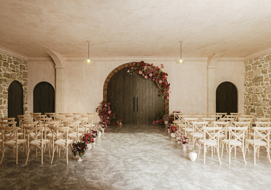 Garden Room at The West Works Glasgow set for a wedding ceremony, with wooden chairs and red and pink floral arrangements around the arched doors