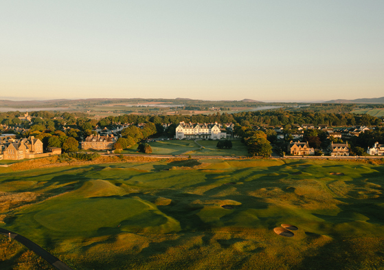 Aerial view of Dornoch Station Hotel wedding venue with championship golf course in the foreground and Scottish Highlands landscape beyond