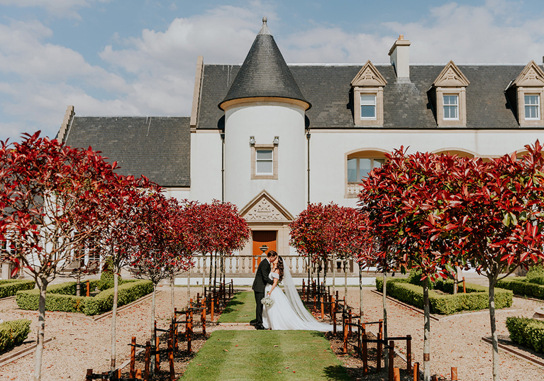 Bride and groom portrait in formal gardens at Ingliston Estate and Country Club in Bishopton