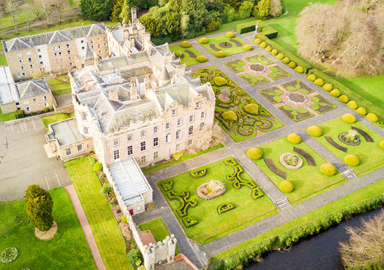 Aerial view of Newbattle Abbey College wedding venue with formal gardens and historic building in Midlothian Scotland