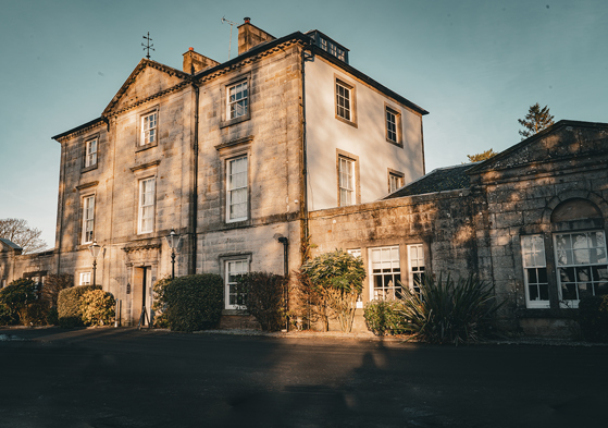 Exterior view of Strathaven Hotel, a historic country house wedding venue in South Lanarkshire with classic stone architecture.