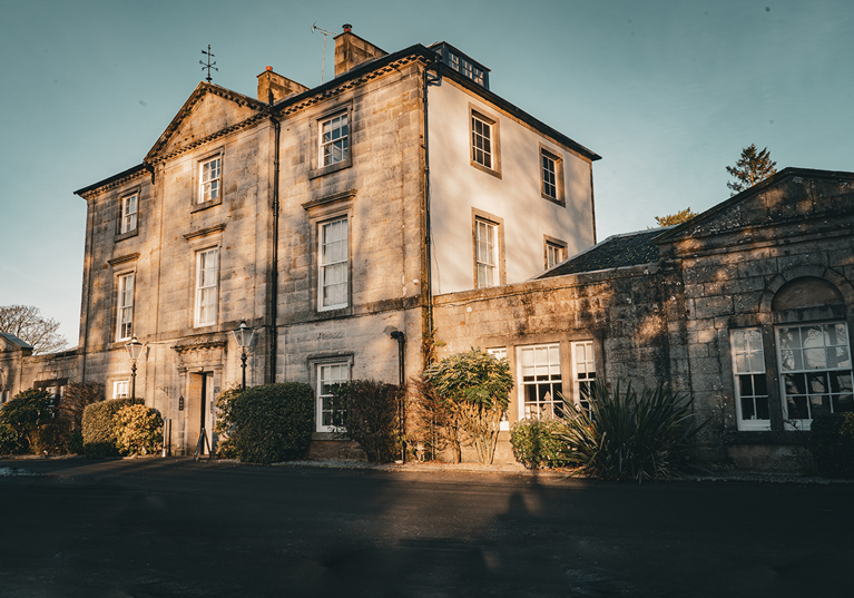 Exterior view of Strathaven Hotel, a historic country house wedding venue in South Lanarkshire with classic stone architecture.