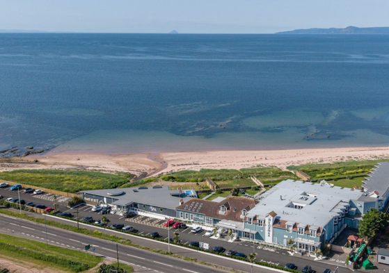 Drone view of The Waterside Hotel & Spa and its surrounding water.