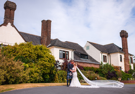 Bride and groom kiss outside Western House Hotel, a wedding venue in Ayrshire.