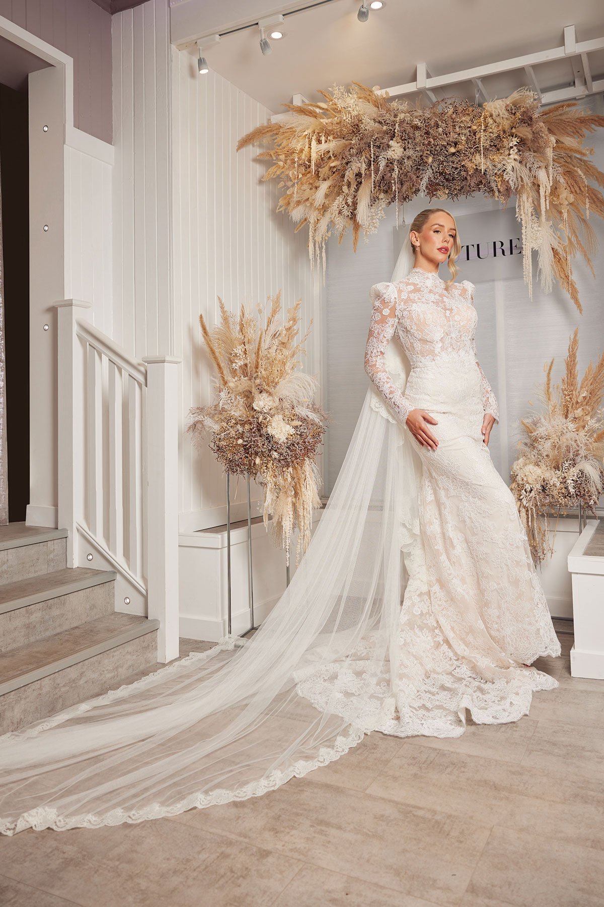 full length picture of model and influencer romy mccahill wears a high neck lace dress from opus couture