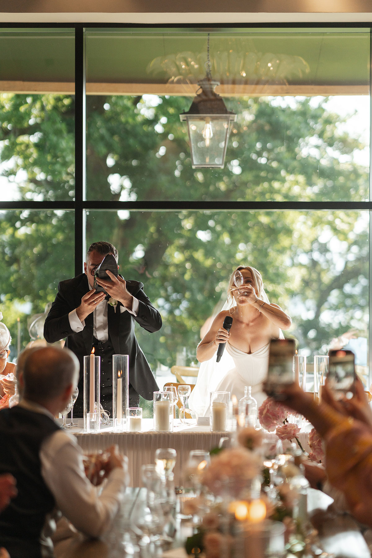 Bride and groom take part in the traditional Australian drinking from the shoe 'shoey' wedding toast during their Boturich Castle reception.