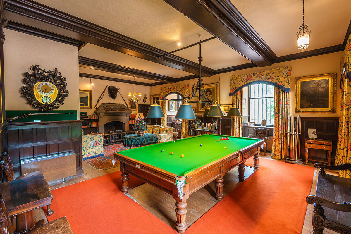 Billiards Room at Fyvie Castle with full-size billiards table, antique furnishings and framed artwork