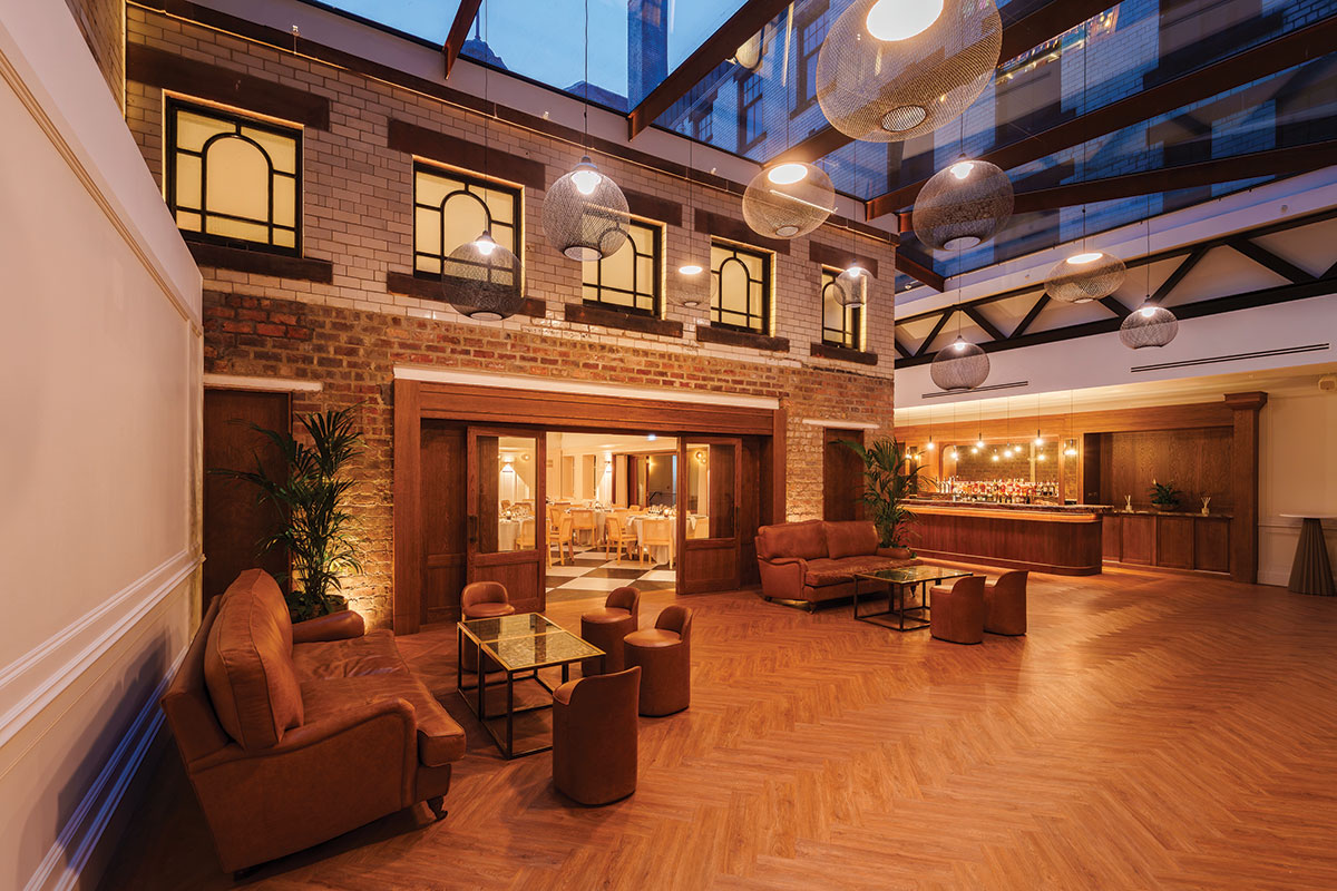 The Collector’s Courtyard at The Collector’s Hall in Glasgow, styled for an evening wedding reception with lounge seating, bar and ambient lighting.