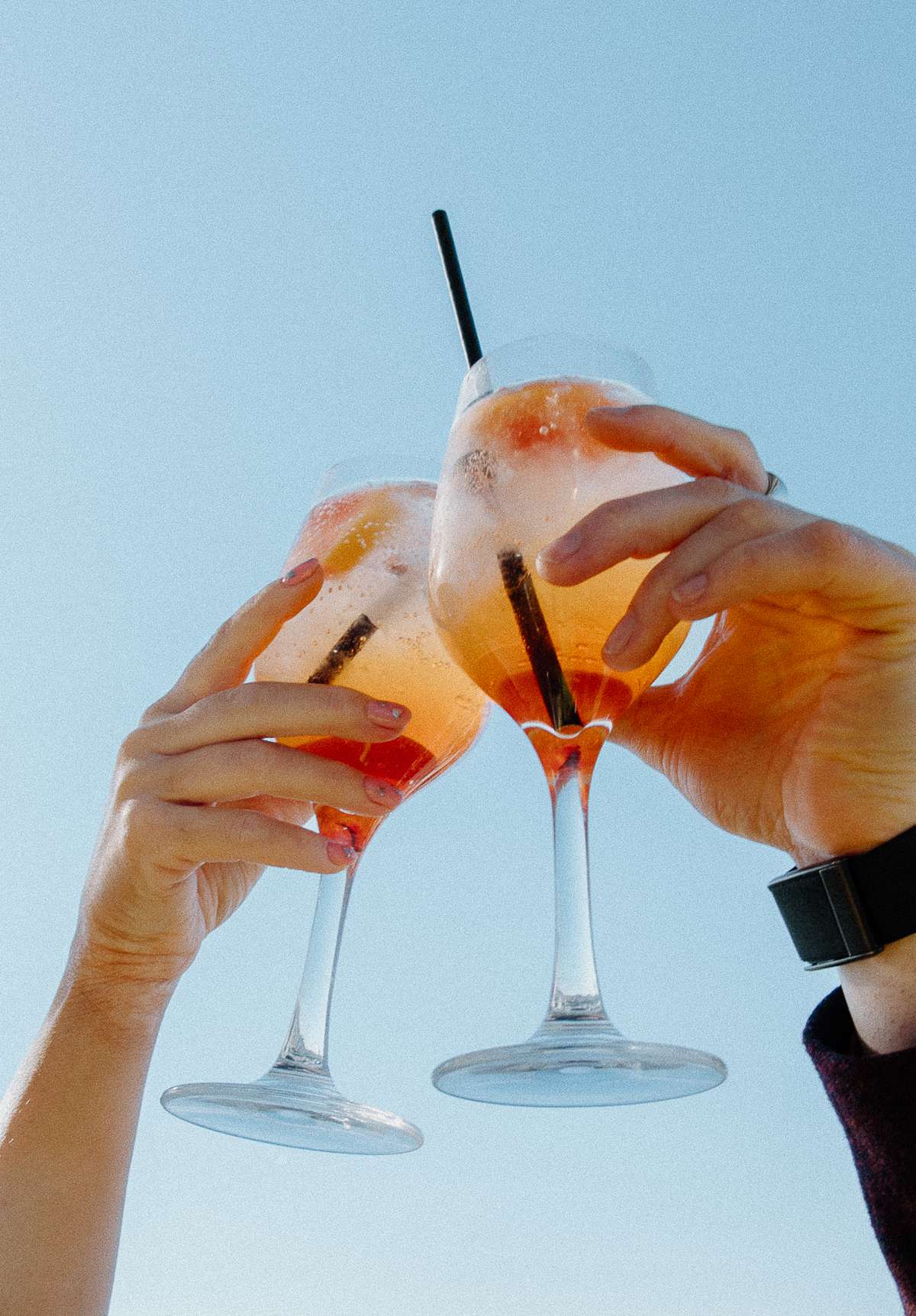Wedding guests raise Aperol Spritz cocktails during the rooftop wedding after-party at The Hoxton Barcelona.