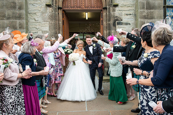 A Bride And Groom Getting Showered In Confetti At St Peters & St Andrews Church In Thurso