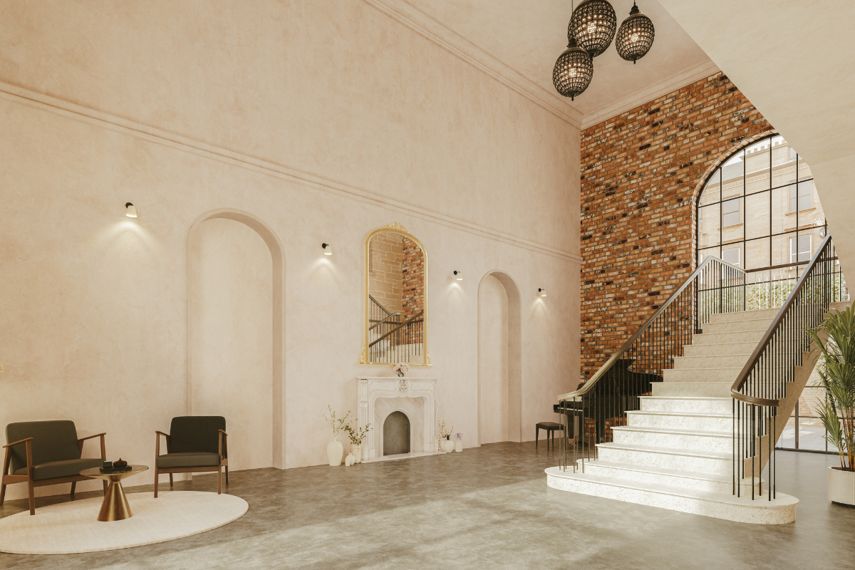 Reception space at The West Works in Glasgow with a statement staircase, exposed brickwork and contemporary seating