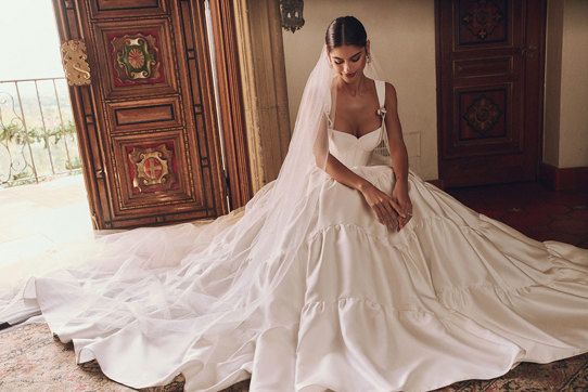 woman in wedding dress and veil sat on the floor under all the tulle layers