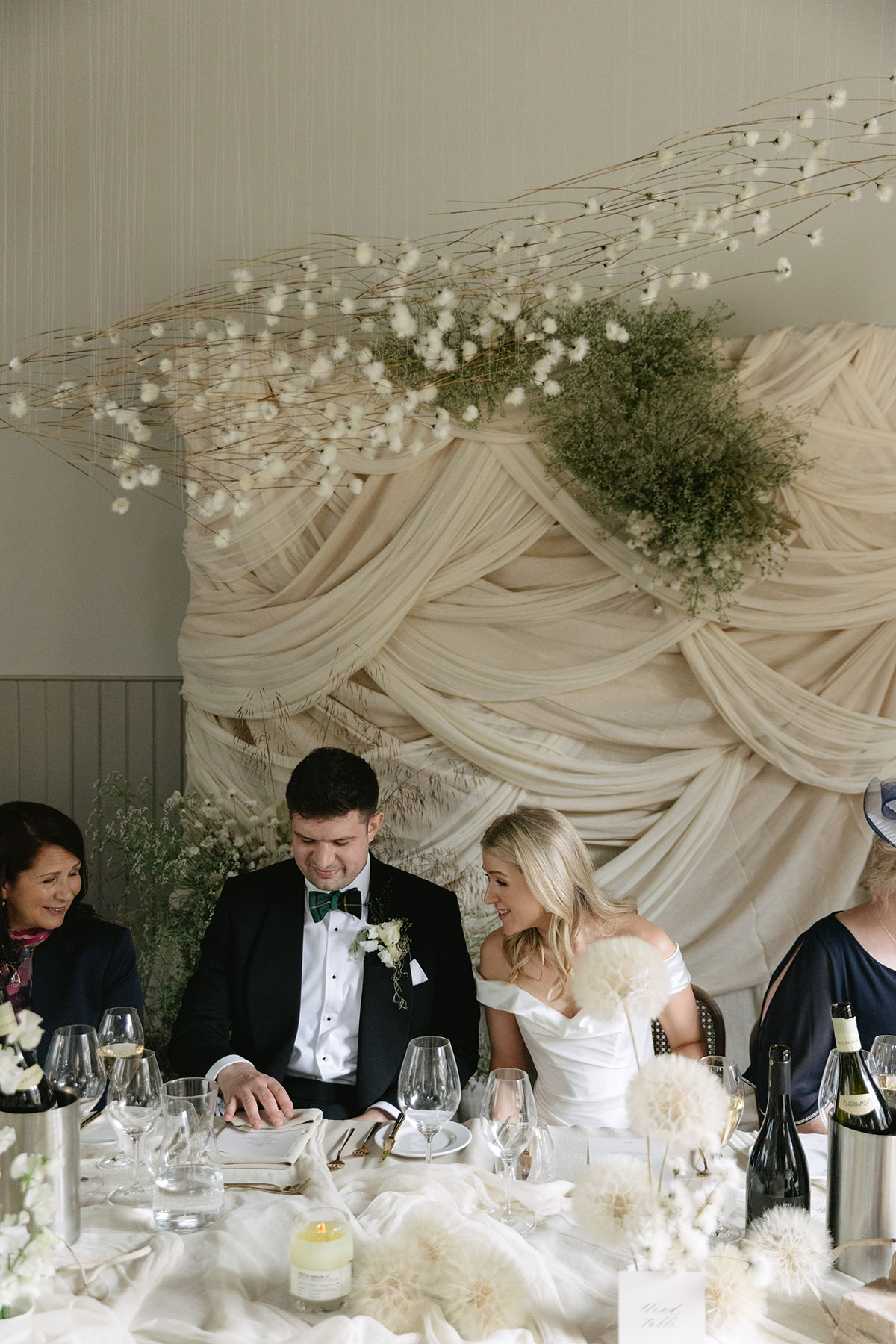 Top table styling with draped backdrop and floral installation at Gilmerton House reception