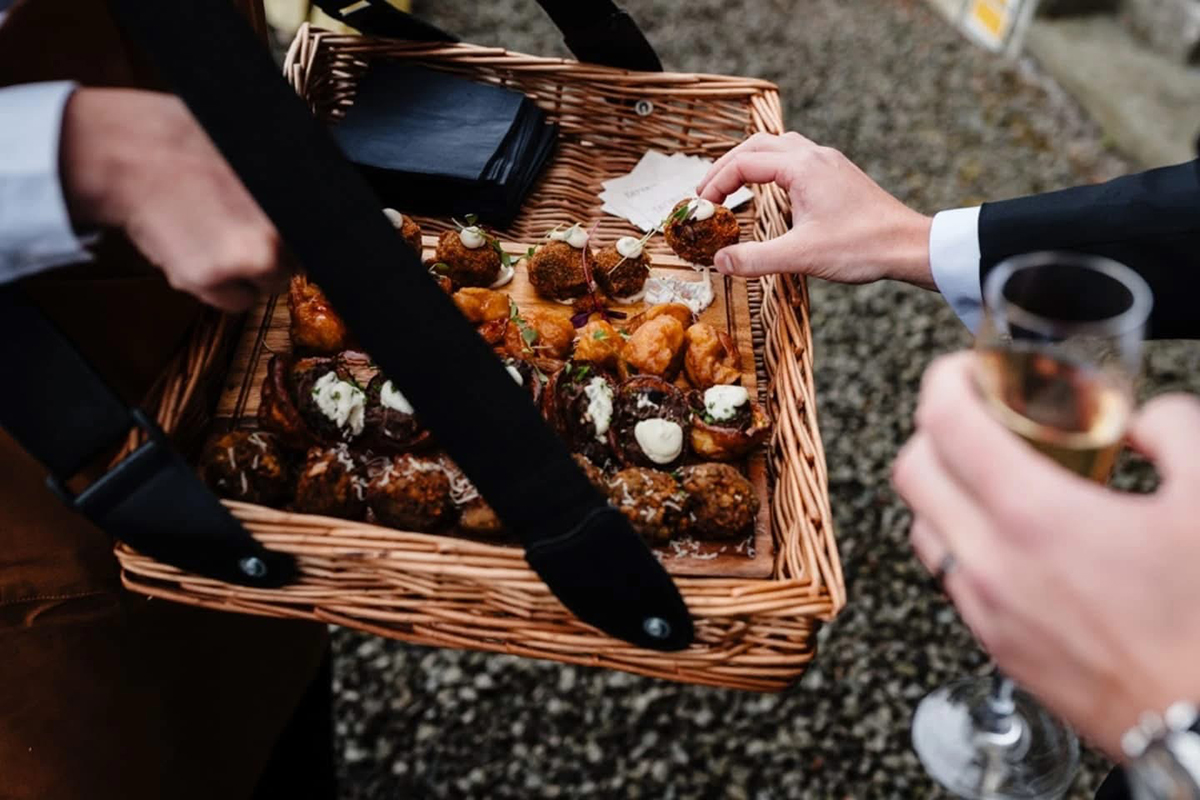 Guest takes canape from basket