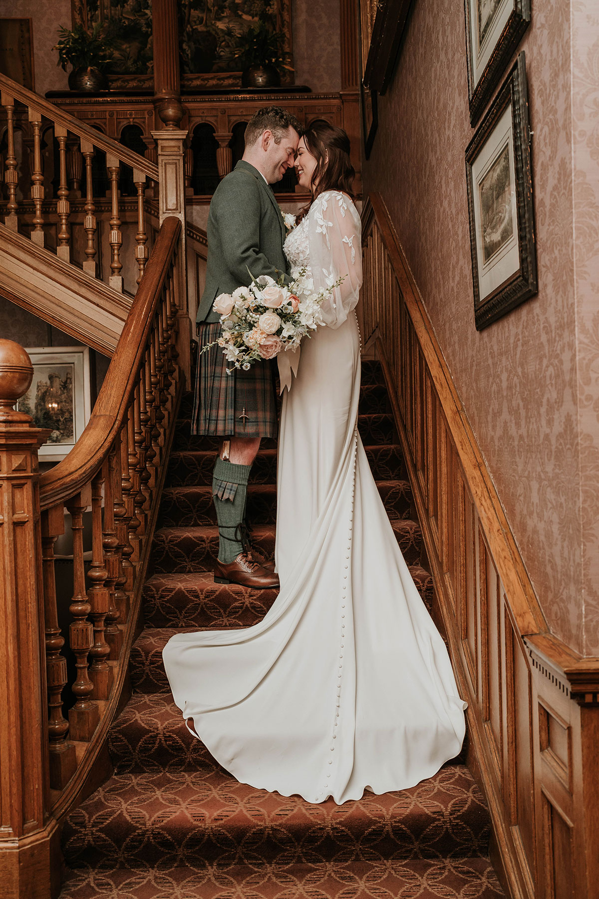 Bride and groom on the grand staircase at Norton House Hotel, Edinburgh wedding