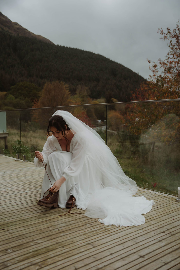 a bride putting on a pair of hiking boots