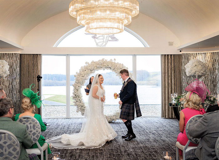 bride and groom laughing at top of aisle