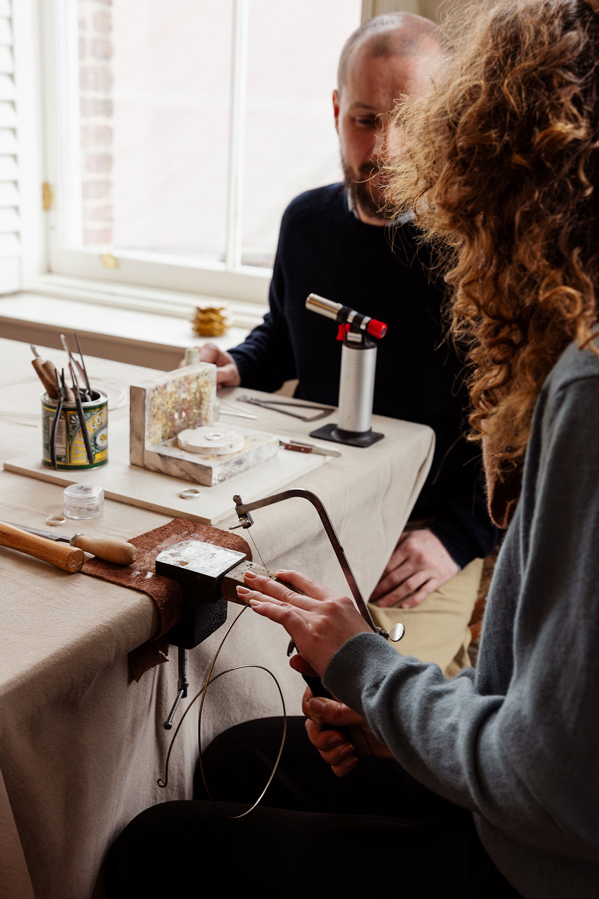 Couple working on wedding rings in jewellery workshop at The Tower Portobello