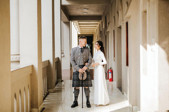 a bride and groom standing in a corridor
