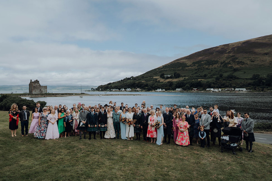 Group shot of the whole wedding party with scenic backdrop