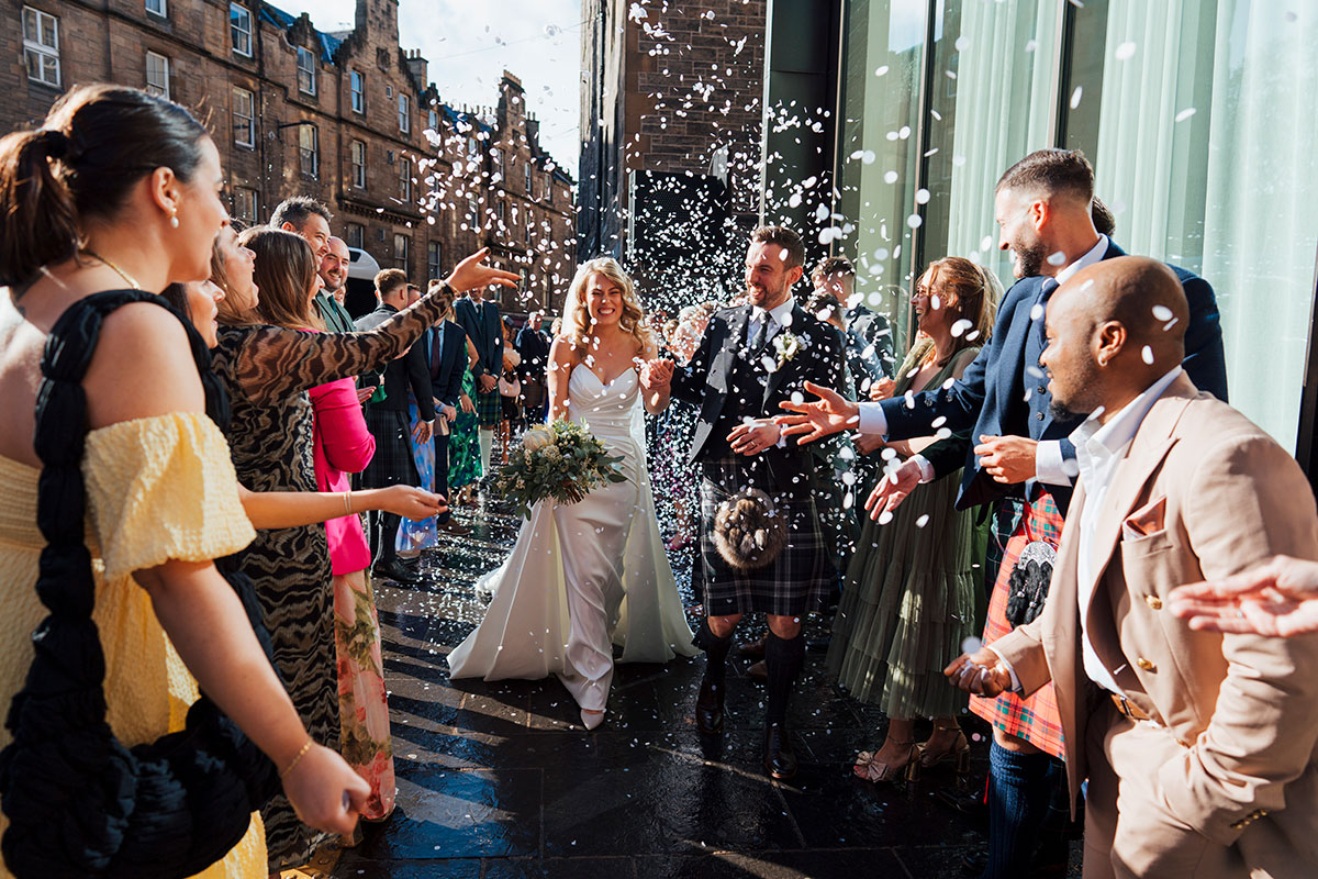 guests throw confetti over bride and groom in edinburgh