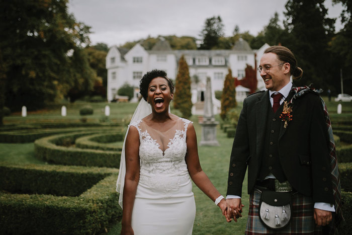 bride and groom smile for photography at wedding at achnagairn castle