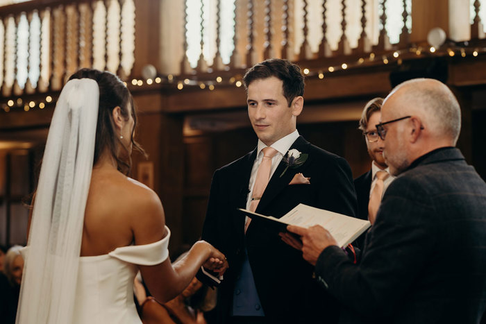 a bride and groom during a wedding ceremony at Achnagairn Castle