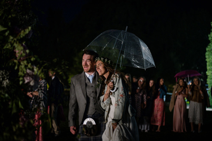 A Bride And Groom At Nighttime With Umbrella At Raemoir House