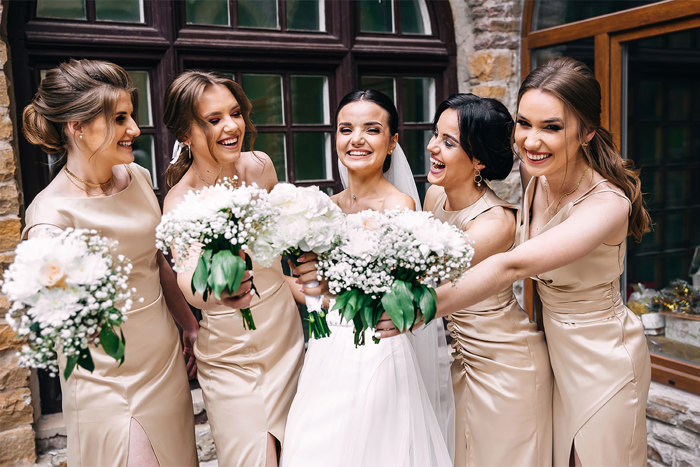 Bride and four bridesmaids holding bouquets 