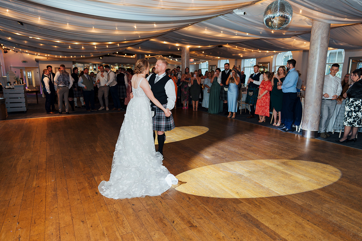 First dance at The Venue Eskmills with guests gathered in decorated reception space