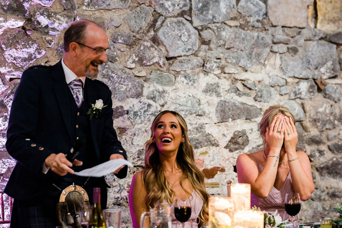 Bridesmaids laugh during speeches
