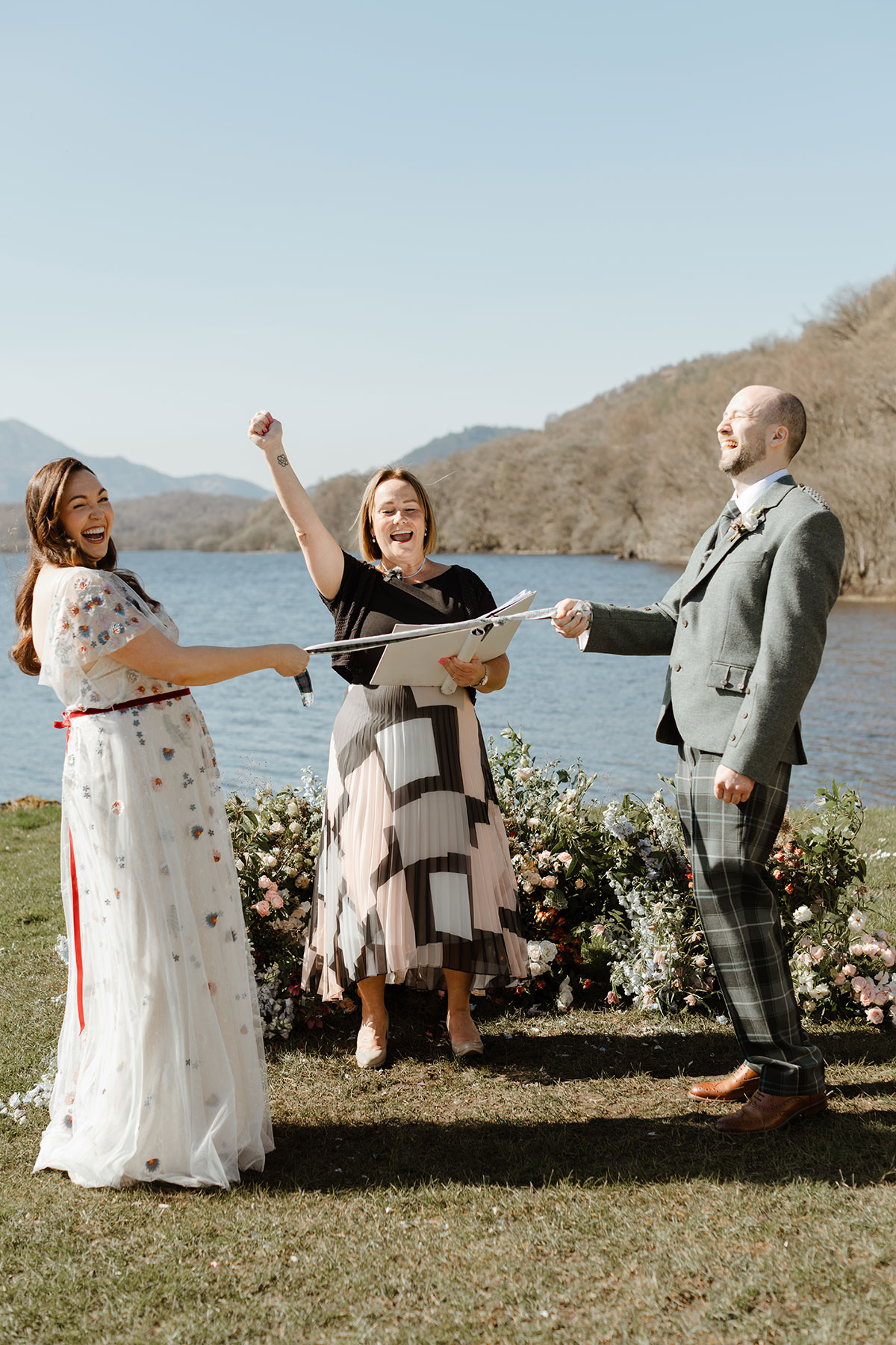 Officiant cheering as couple are handfasting