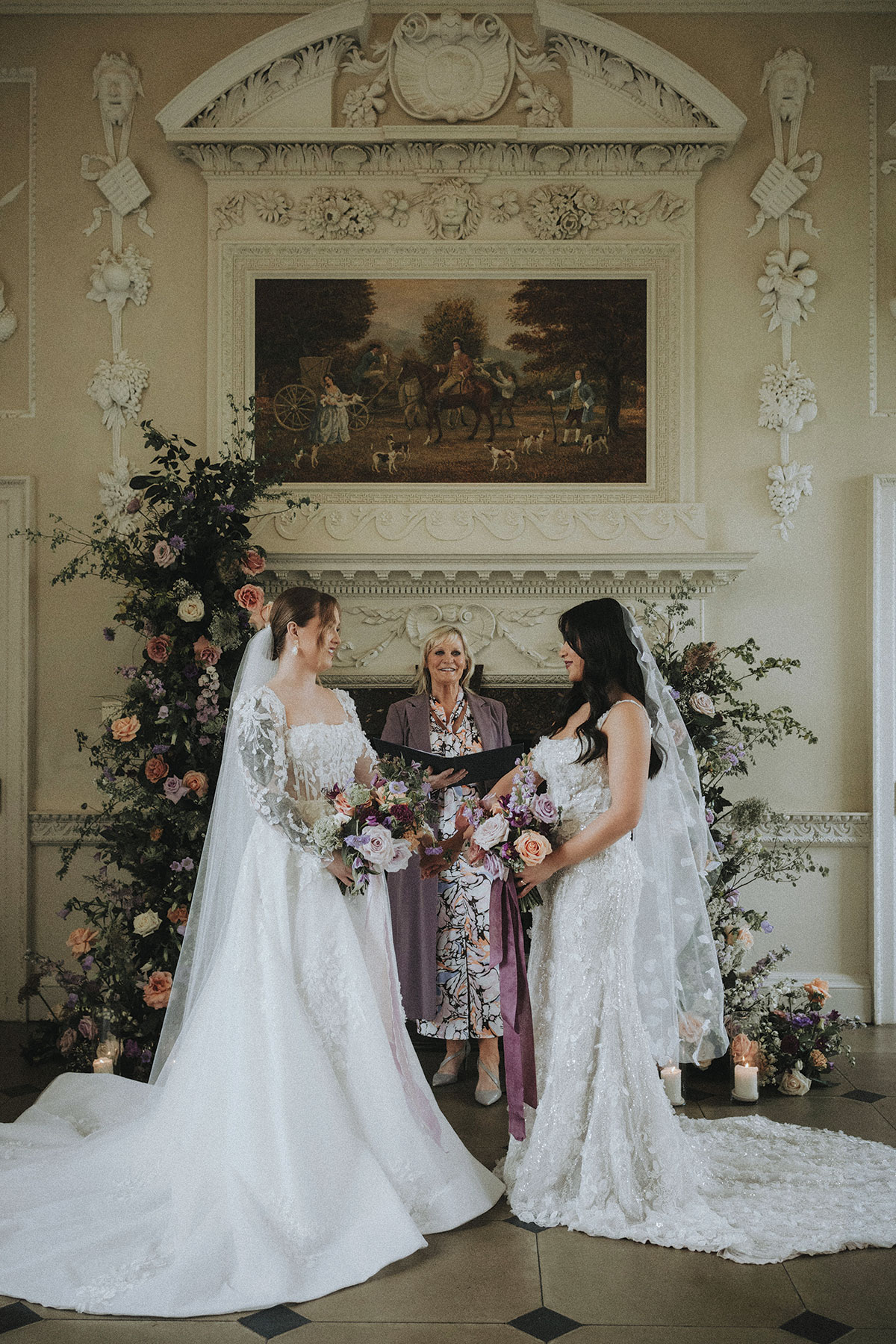 Niki Smith Fulcrum Foundation celebrant stands next to two brides during a wedding ceremony