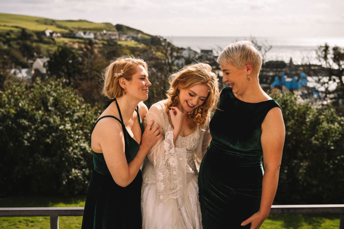 Bride And Bridesmaids Laughing Overlooking Portpatrick