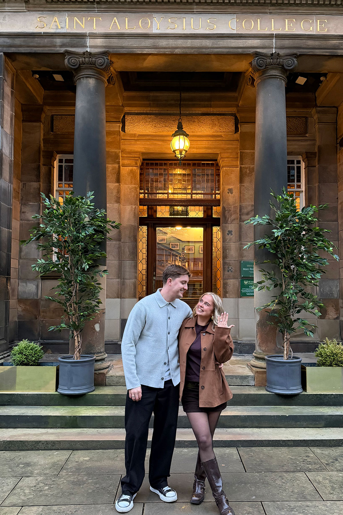 Ruby McFarlane and Oskar Wilkie outside St Aloysius’ College in Glasgow after their engagement, with Ruby showing her engagement ring.