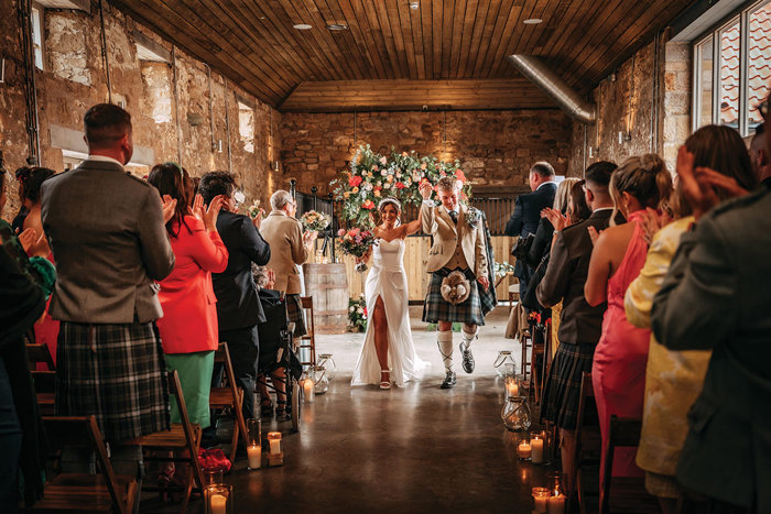 bride and groom cheer after wedding ceremony at falside mill