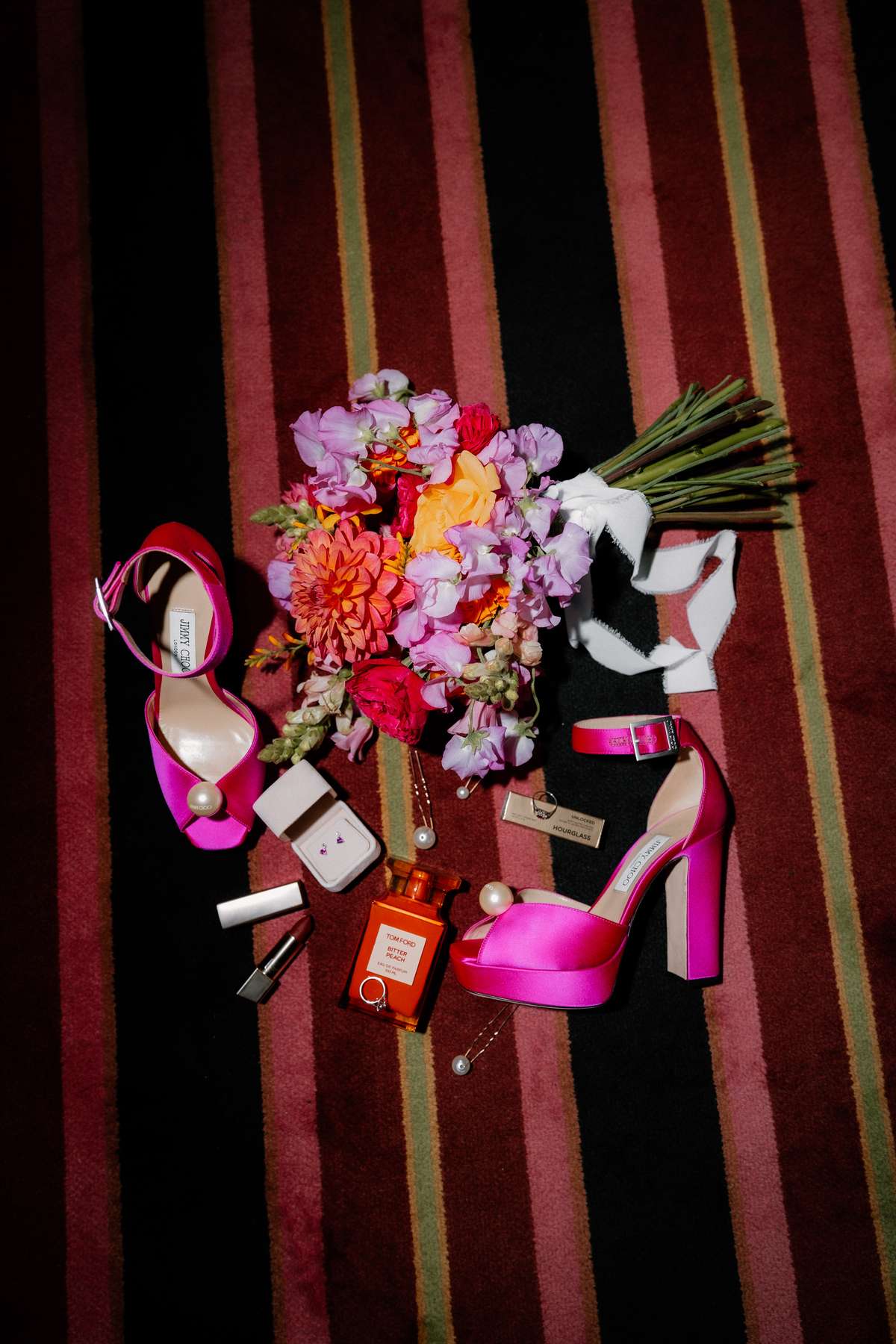Kara’s bright pink Jimmy Choo wedding shoes displayed with her colourful bouquet, jewellery and bridal accessories