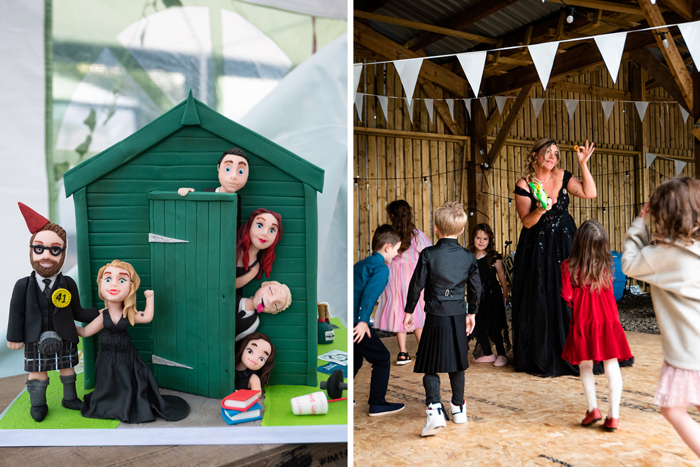 A Green Shed Cake Topper With Bride, Groom And Four Other Characters Poking Heads Out Of Green Door On Left And A Bride Wearing A Black Dress Dances Surrounded By Children In A Wooden Shed Setting