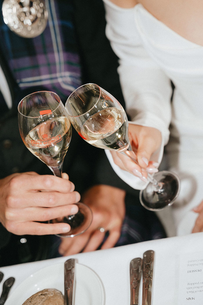 bride and groom cheers champagne glasses