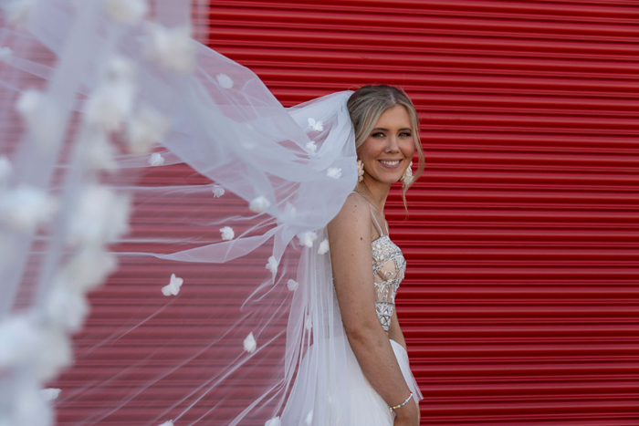 Bride's 3D-flower adorned veil flies towards the camera