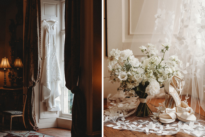 An Eleganza Sposa Wedding Dress Hanging In A Window And A White Wedding Bouquet And Ivory Wedding Shoes