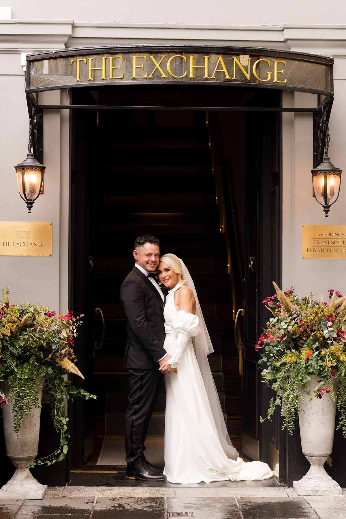 Bride and groom standing at the entrance to The Exchange wedding venue in Glasgow